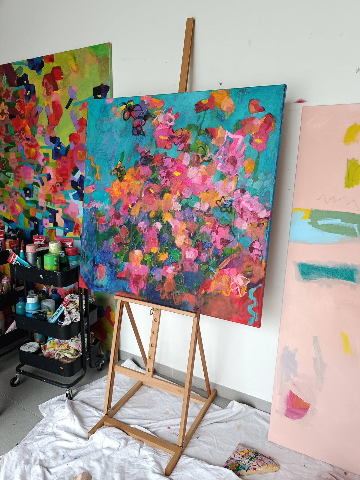 Vibrant abstract botanical painting displayed on artist easel
