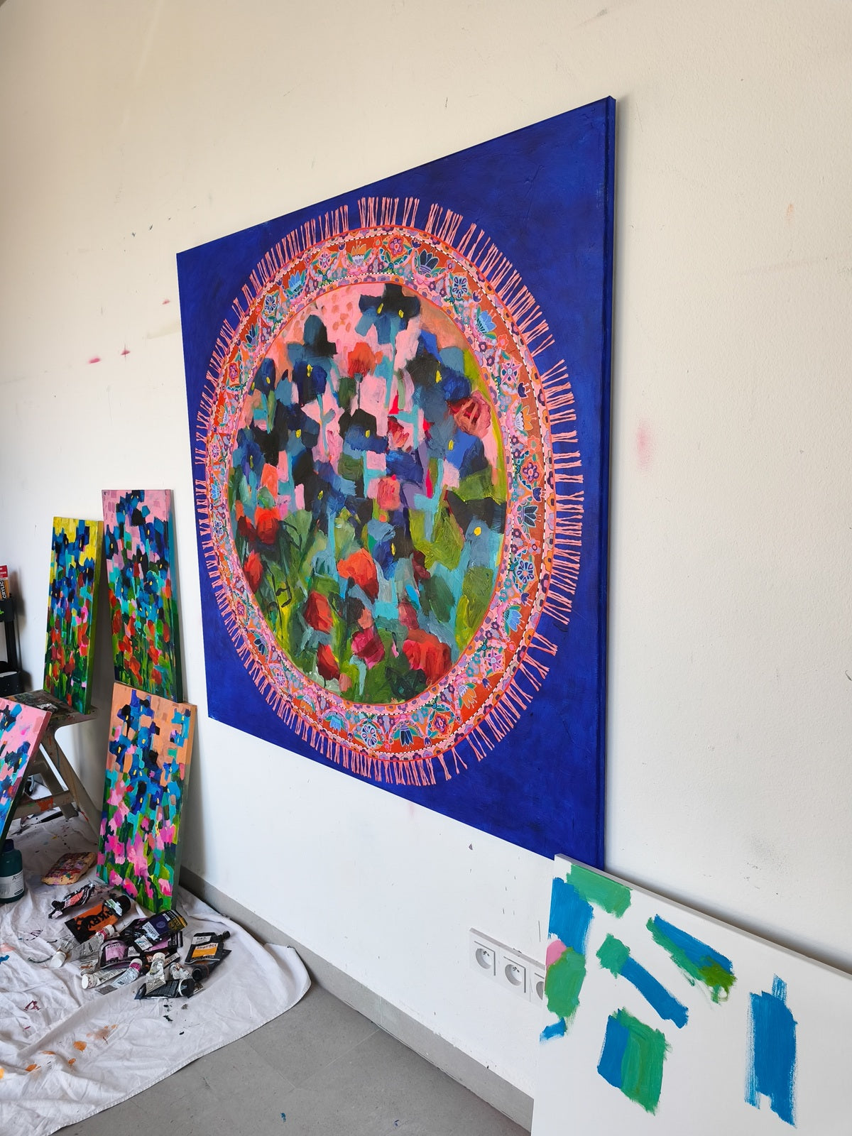 Abstract painting inspired by round carpet with iris flowers, red accents and pink tones, full composition