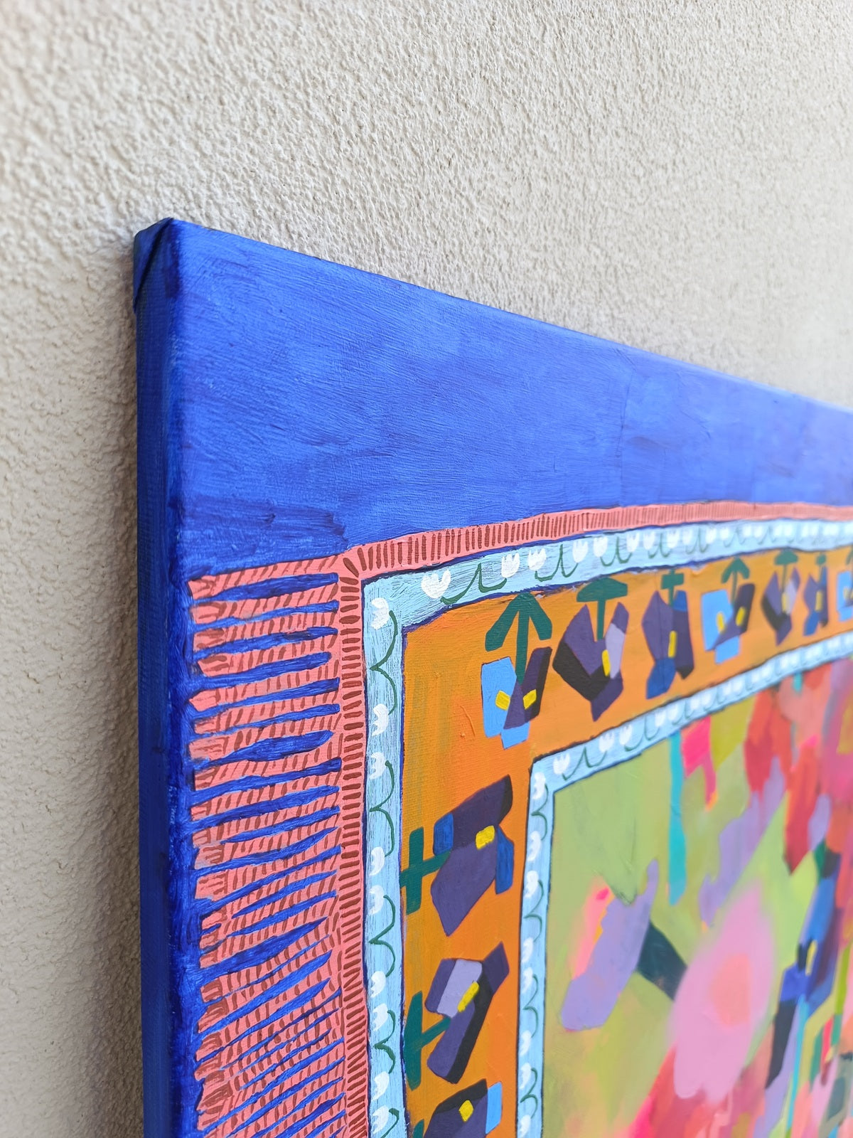 Side view of stretched canvas with ultramarine painted edges on large abstract artwork