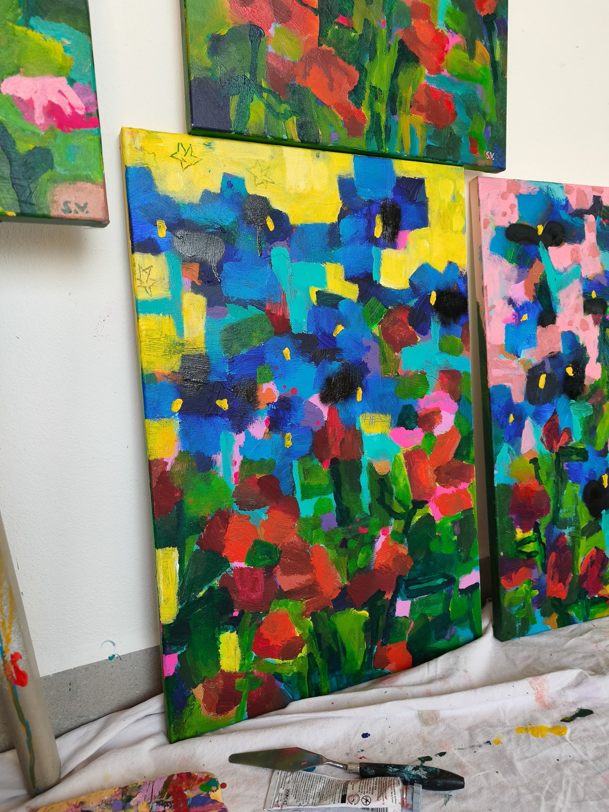 Small abstract floral painting Ultramarine Meadow, 40x60 cm with yellow sky, small stars, blue iris flowers and red accents