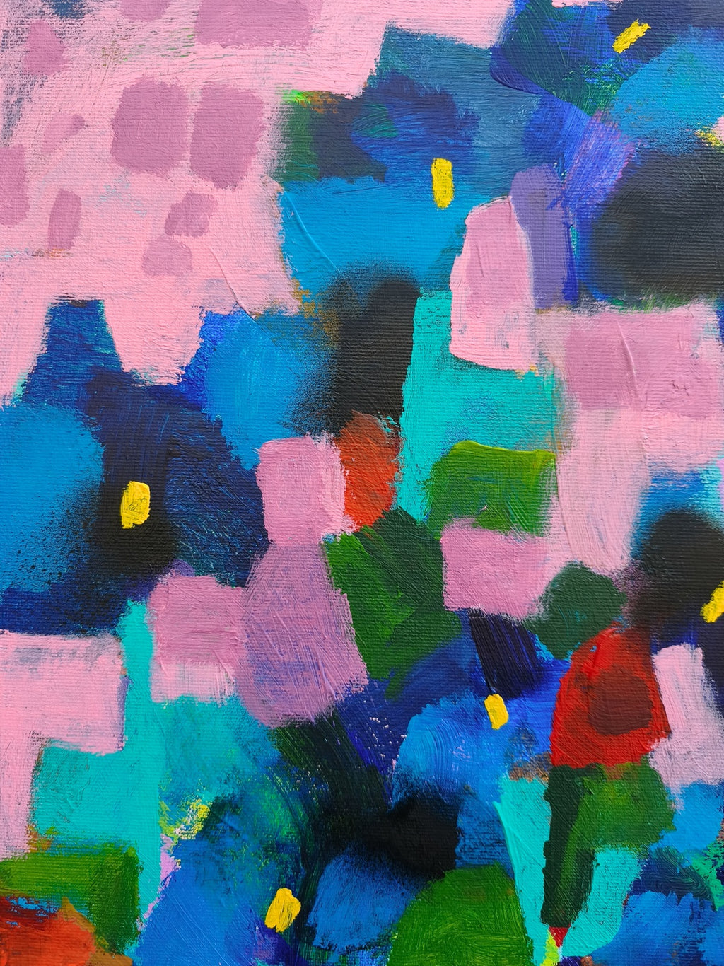 Close-up of abstract floral wall art with blue iris flowers and red floral accents on pink background