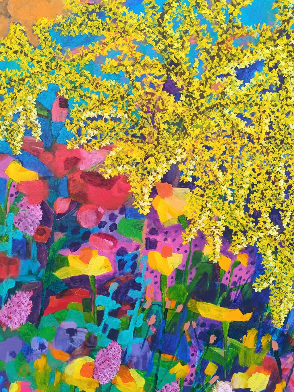 Close-up of colorful floral elements in abstract painting with pink, blue and red accents